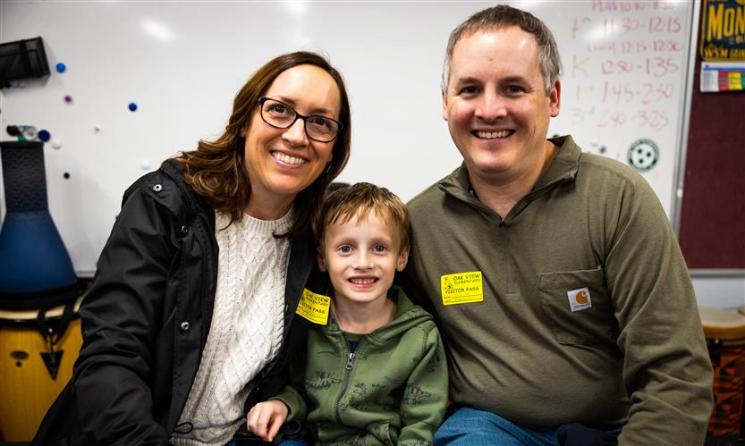 A students smiles with their parents